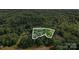A scenic aerial view showcases a wooded lot with mature trees, providing privacy and a natural setting at 000A Duck Cove Rd, Belmont, NC 28012