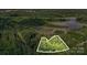A scenic aerial view showcases a wooded lot with mature trees, providing privacy and a natural setting at 000A Duck Cove Rd, Belmont, NC 28012