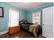 This bedroom features a window for natural light and hardwood floors for a cozy and classic feel at 1001 N Cannon Blvd, Kannapolis, NC 28083