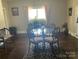 Bright dining area featuring a round glass table set on a decorative rug near a window at 1001 N Cannon Blvd, Kannapolis, NC 28083
