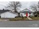 Street view of a charming home with a bright red door and detached garage at 1001 N Cannon Blvd, Kannapolis, NC 28083