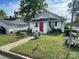 Charming home featuring a vibrant red front door, white siding, and well-maintained lawn, creating a welcoming curb appeal at 1001 N Cannon Blvd, Kannapolis, NC 28083
