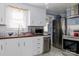 Well-equipped kitchen with stainless steel appliances, bright white cabinets, and lots of natural light at 1001 N Cannon Blvd, Kannapolis, NC 28083