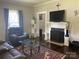Comfortable living room with plush seating, fireplace, and natural light from the window at 1001 N Cannon Blvd, Kannapolis, NC 28083