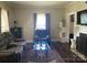 Comfortable living room with plush seating, fireplace, and natural light from the window at 1001 N Cannon Blvd, Kannapolis, NC 28083
