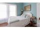 The main bedroom is bright and airy, with a cozy bed and quaint decor, providing a peaceful ambiance at 1001 N Cannon Blvd, Kannapolis, NC 28083