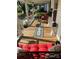 Inviting porch with red cushions, a stylish rug, potted plants, and charming decor, offering a relaxing outdoor space at 1001 N Cannon Blvd, Kannapolis, NC 28083