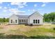 Spacious backyard featuring a covered patio, large windows, and lush greenery, creating a private retreat at 1037 Dameron Rd, Bessemer City, NC 28016