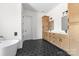 Bathroom features a soaking tub, and double vanity with quartz counters at 1037 Dameron Rd, Bessemer City, NC 28016