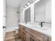 Modern bathroom featuring a double vanity, and shower with nice tile surround at 1037 Dameron Rd, Bessemer City, NC 28016