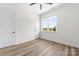Bright bedroom featuring a ceiling fan, a window with a view, and wood-look flooring at 1037 Dameron Rd, Bessemer City, NC 28016