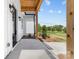 Covered entryway featuring natural wood beams and a clear view of the lush backyard at 1037 Dameron Rd, Bessemer City, NC 28016