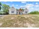 Charming white farmhouse featuring a welcoming front porch and black front door with a well-manicured lawn at 1037 Dameron Rd, Bessemer City, NC 28016