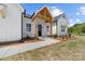 Charming front porch with natural wood beams, a black front door, and manicured landscaping at 1037 Dameron Rd, Bessemer City, NC 28016