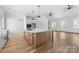 Open kitchen with modern island, stainless oven, and white cabinets at 1037 Dameron Rd, Bessemer City, NC 28016