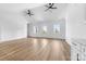 Bright living room features high ceilings, ceiling fans, and wood-look flooring at 1037 Dameron Rd, Bessemer City, NC 28016