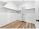 Spacious walk-in closet with built in shelving and wood-look floors at 1037 Dameron Rd, Bessemer City, NC 28016