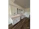 Elegant wet bar with white cabinets, glass door uppers, and a stylish countertop on wood floor at 1037 Dameron Rd, Bessemer City, NC 28016