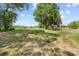 Beautiful large yard with lush green grass, mature trees, and an open space at 1037 Dameron Rd, Bessemer City, NC 28016