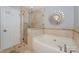 Bright bathroom featuring a soaking tub, glass-enclosed shower, and decorative mirror at 107 Pier 33 Dr # 103, Mooresville, NC 28117