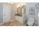 Bathroom with double sinks, mirrors, and toilet at 107 Pier 33 Dr # 103, Mooresville, NC 28117