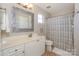 Bathroom with decorative mirror, modern vanity, and patterned shower curtain at 107 Pier 33 Dr # 103, Mooresville, NC 28117