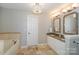 Bright bathroom with double sinks and a soaking tub at 107 Pier 33 Dr # 103, Mooresville, NC 28117