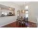 Dining area with a view of the kitchen, featuring hardwood floors and a modern pendant light fixture at 107 Pier 33 Dr # 103, Mooresville, NC 28117
