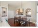 Dining room with a view of the kitchen, adjacent to the living room, featuring hardwood floors and a stylish light fixture at 107 Pier 33 Dr # 103, Mooresville, NC 28117