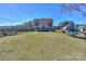 View of the condo building from the lawn, showing the balcony and lake access with boat storage at 107 Pier 33 Dr # 103, Mooresville, NC 28117