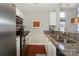 Well-lit kitchen featuring granite countertops and a stainless steel sink at 107 Pier 33 Dr # 103, Mooresville, NC 28117