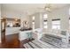 Open-concept living room with high ceilings, ceiling fan, hardwood floors, and views to the kitchen and dining area at 107 Pier 33 Dr # 103, Mooresville, NC 28117