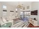 Living room featuring a ceiling fan, patio access and views, and a comfortable seating area with modern decor at 107 Pier 33 Dr # 103, Mooresville, NC 28117