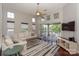 Bright living room with plush seating, TV, and sliding glass doors to balcony, offering stunning views and indoor-outdoor living at 107 Pier 33 Dr # 103, Mooresville, NC 28117