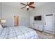 Main bedroom with ceiling fan, dresser, ensuite bathroom and exterior door at 107 Pier 33 Dr # 103, Mooresville, NC 28117