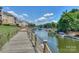 Scenic waterfront with a wooden boardwalk, boat docks, and lovely views of the lake and surrounding greenery at 107 Pier 33 Dr # 103, Mooresville, NC 28117