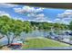 Beautiful waterfront view with boat dock, lush green lawn, and colorful kayaks perfect for outdoor lake living at 107 Pier 33 Dr # 103, Mooresville, NC 28117