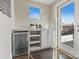 Wet bar area featuring built-in shelving and a mini-fridge at 107 W Poindexter Dr, Charlotte, NC 28203