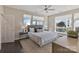 Bright bedroom featuring a large bed, neutral decor, ample natural light, and a ceiling fan at 107 W Poindexter Dr, Charlotte, NC 28203