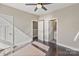 Bedroom showcasing hardwood floors with doors to closet and bathroom at 107 W Poindexter Dr, Charlotte, NC 28203