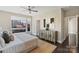 Bedroom showcasing a bed with decorative pillows, natural light, and a modern dresser with unique hardware at 107 W Poindexter Dr, Charlotte, NC 28203