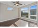 Bright bedroom featuring hardwood floors, large windows, and a ceiling fan at 107 W Poindexter Dr, Charlotte, NC 28203