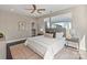 Bedroom with a neutral color palette, a cozy rug, side tables, and ample natural light from large windows at 107 W Poindexter Dr, Charlotte, NC 28203