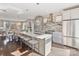 Contemporary kitchen featuring a central island, stainless steel appliances, and seamless flow to the dining area at 107 W Poindexter Dr, Charlotte, NC 28203