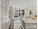 Sleek kitchen featuring modern appliances, quartz countertops, subway tile backsplash and natural lighting at 107 W Poindexter Dr, Charlotte, NC 28203