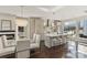 Open kitchen and dining area showcasing a stylish chandelier, island with seating, and modern appliances at 107 W Poindexter Dr, Charlotte, NC 28203