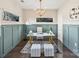 Home office featuring a sleek desk, modern lighting, wainscoting and ample natural light at 107 W Poindexter Dr, Charlotte, NC 28203