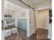 Bright office space with wainscoting, chandelier, and sliding barn door, creating a functional workspace at 107 W Poindexter Dr, Charlotte, NC 28203