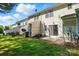 View of the back of the house showing back patios and green grass with neighborhood trash cans at 110 Rhett Ct, Fort Mill, SC 29715