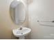 Bathroom featuring pedestal sink, oval mirror, and chrome fixtures at 110 Rhett Ct, Fort Mill, SC 29715